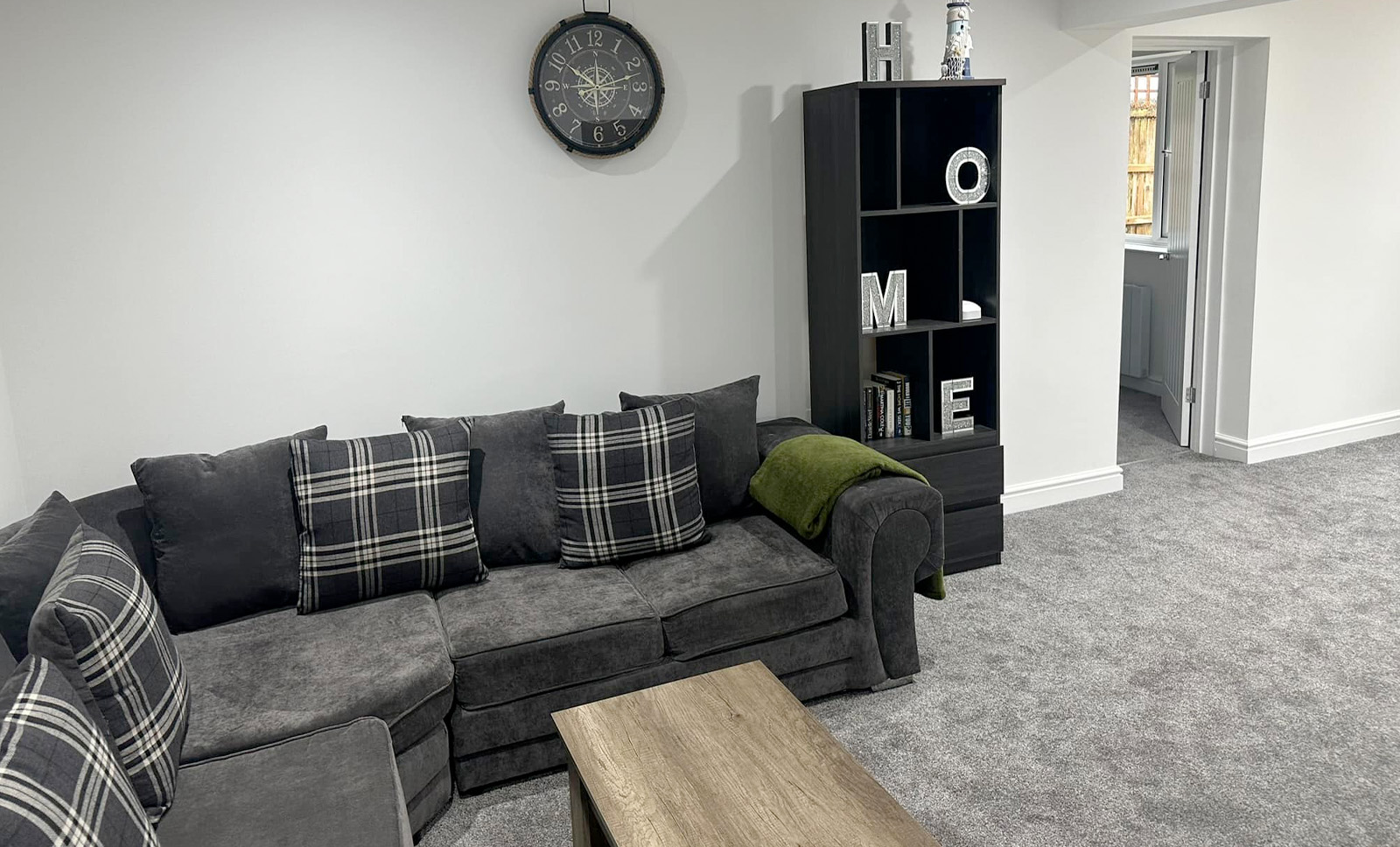 Interior image of a grey sofa in a cozy room with decorative pillows on it